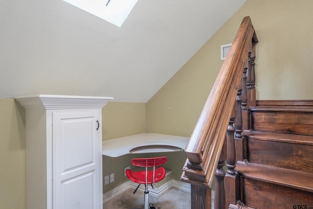 stairs featuring carpet flooring and lofted ceiling