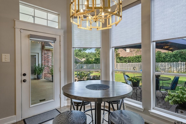 sunroom featuring a chandelier