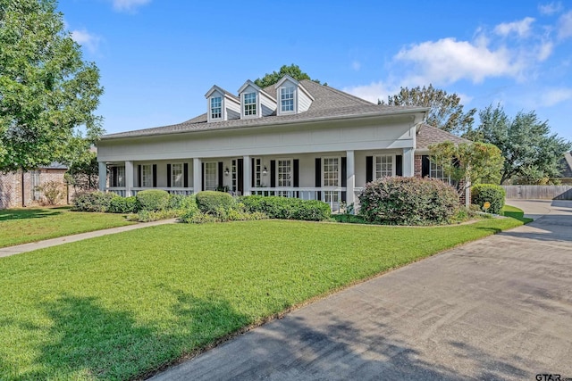 view of front of home featuring a front yard and a porch