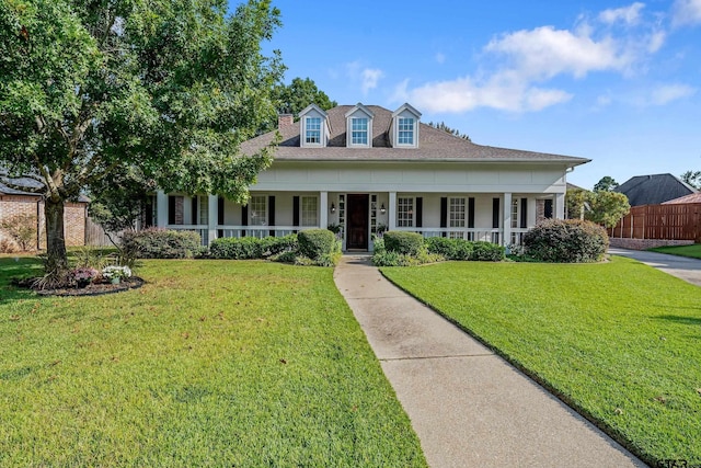 view of front facade featuring covered porch and a front yard