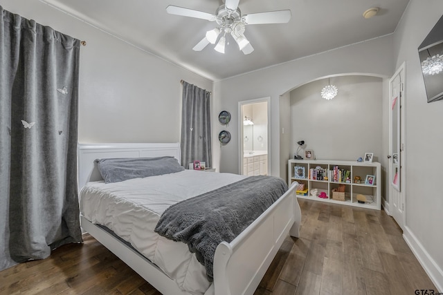 bedroom with ceiling fan, dark hardwood / wood-style flooring, and connected bathroom