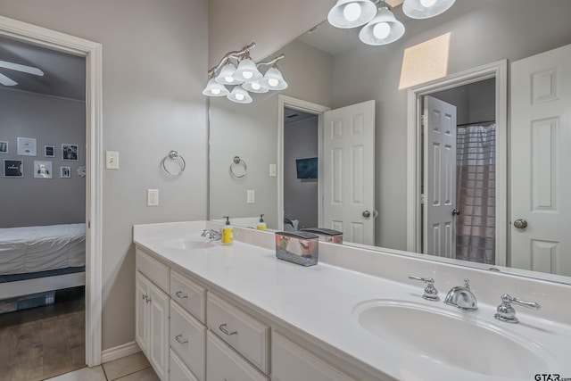 bathroom with tile patterned floors, vanity, and ceiling fan