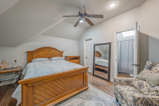 bedroom with vaulted ceiling, light hardwood / wood-style flooring, and ceiling fan