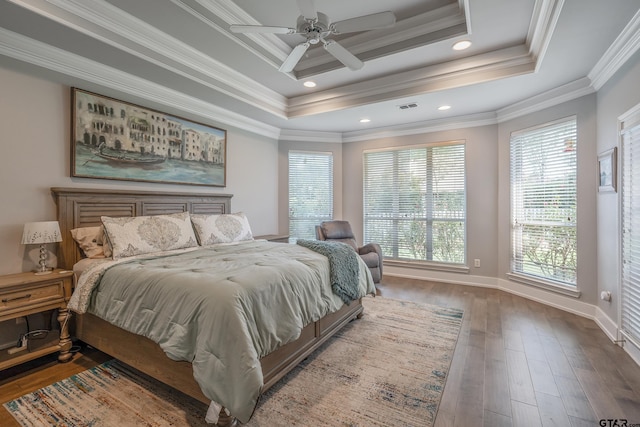 bedroom with multiple windows, ceiling fan, crown molding, and wood-type flooring