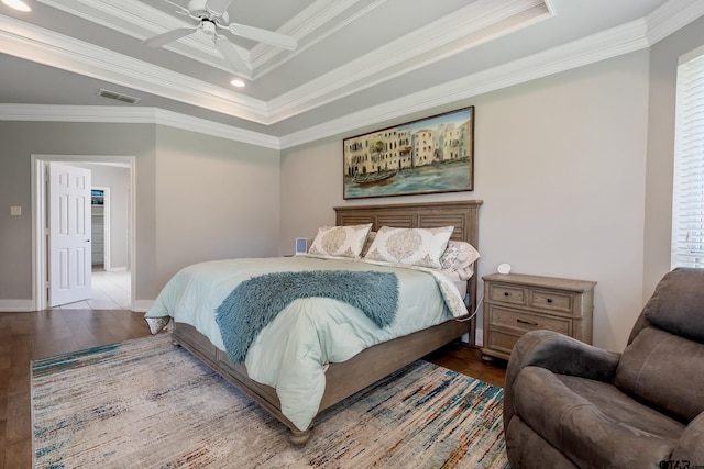 bedroom featuring hardwood / wood-style floors, ceiling fan, and ornamental molding