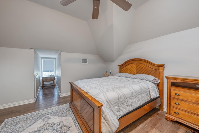 bedroom with dark hardwood / wood-style floors, ceiling fan, and vaulted ceiling