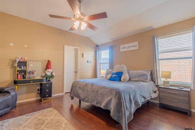 bedroom with ceiling fan, dark wood-type flooring, and vaulted ceiling