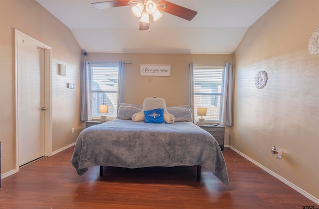 bedroom with vaulted ceiling, multiple windows, and ceiling fan