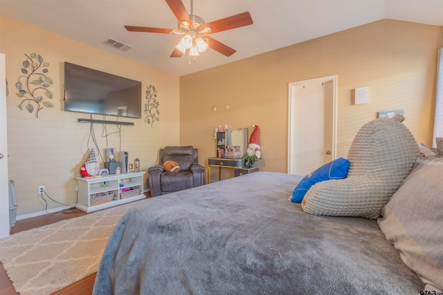 bedroom featuring hardwood / wood-style floors, ceiling fan, and lofted ceiling