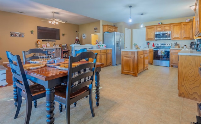 dining room with ceiling fan and sink