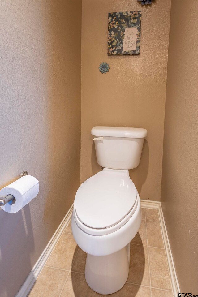 bathroom with tile patterned flooring and toilet