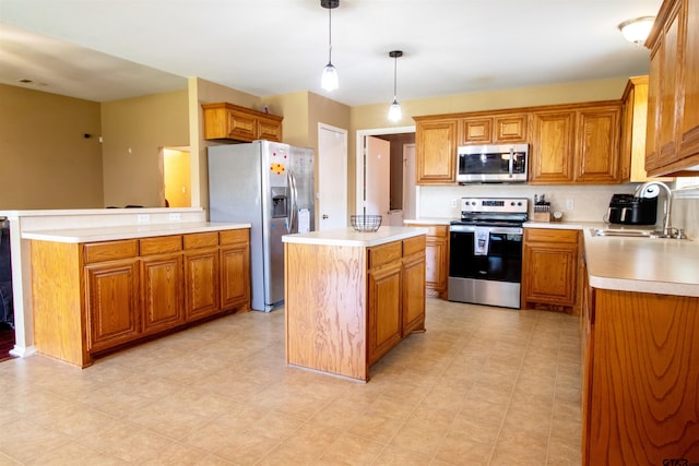 kitchen with light countertops, a kitchen island, brown cabinetry, appliances with stainless steel finishes, and a sink