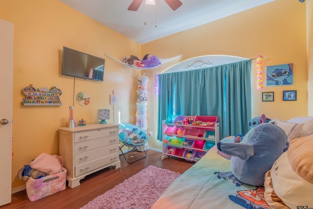 bedroom featuring ceiling fan and dark wood-type flooring