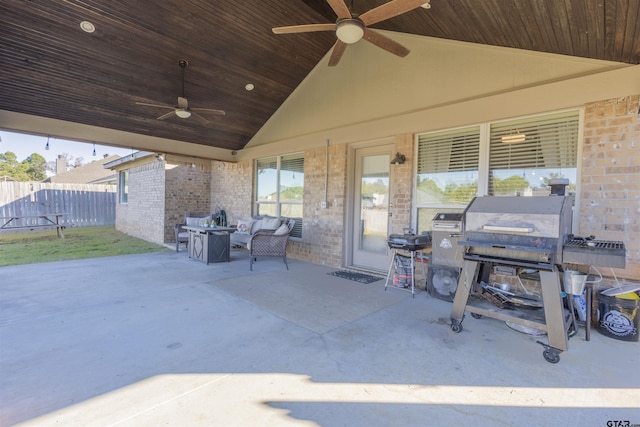 view of patio with outdoor lounge area, fence, and a ceiling fan