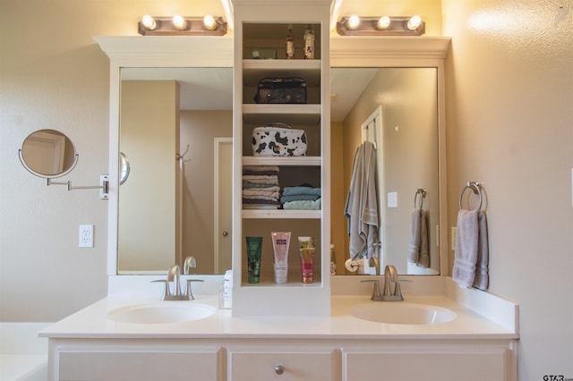 full bathroom featuring a sink and double vanity