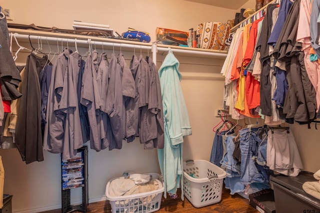 spacious closet featuring dark hardwood / wood-style flooring