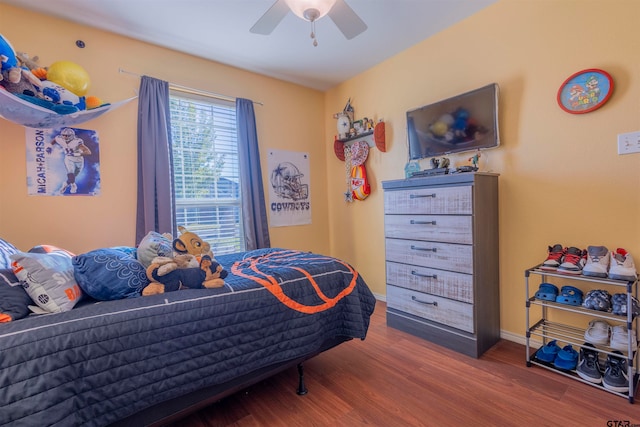 bedroom with ceiling fan and hardwood / wood-style flooring