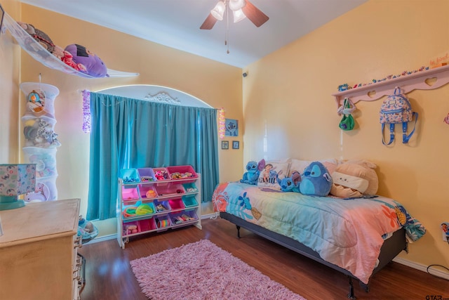 bedroom with dark hardwood / wood-style floors and ceiling fan