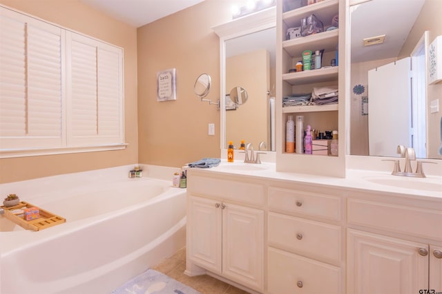 bathroom with tile patterned flooring, vanity, and a tub to relax in