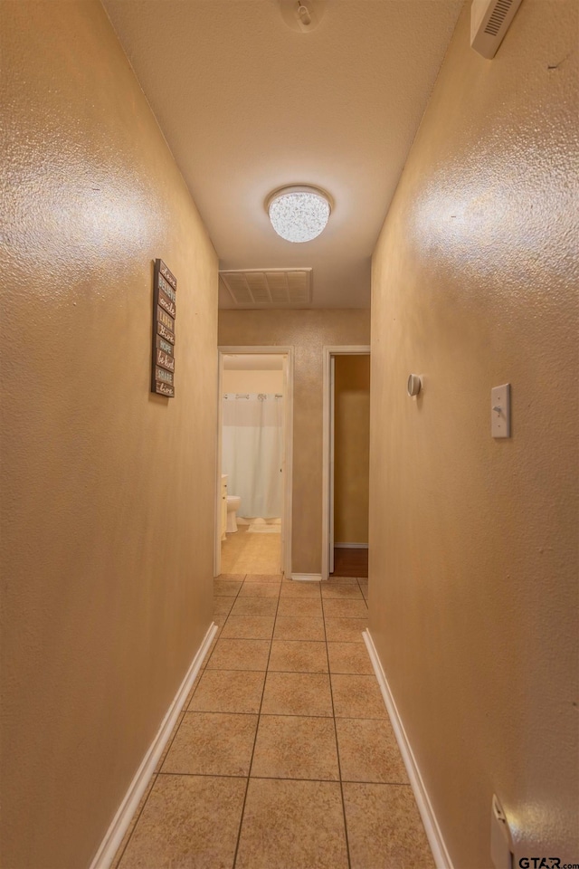 hallway with light tile patterned floors