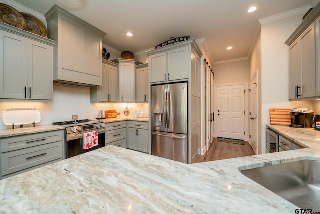 4523 Lone Oak Ln, Longview, TX 75605 - kitchen featuring appliances with stainless steel finishes, gray cabinets, crown molding, light stone counters, and backsplash