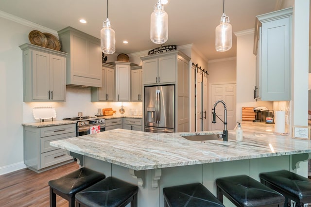 4523 Lone Oak Ln, Longview, TX 75605 - kitchen featuring appliances with stainless steel finishes, a peninsula, light stone counters, gray cabinets, and a kitchen breakfast bar