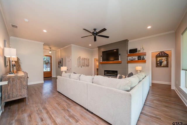 4523 Lone Oak Ln, Longview, TX 75605 - living room with a fireplace, wood finished floors, ceiling fan, ornamental molding, and recessed lighting