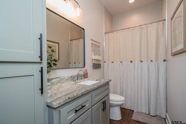 4523 Lone Oak Ln, Longview, TX 75605 - bathroom featuring vanity, wood finished floors, and recessed lighting