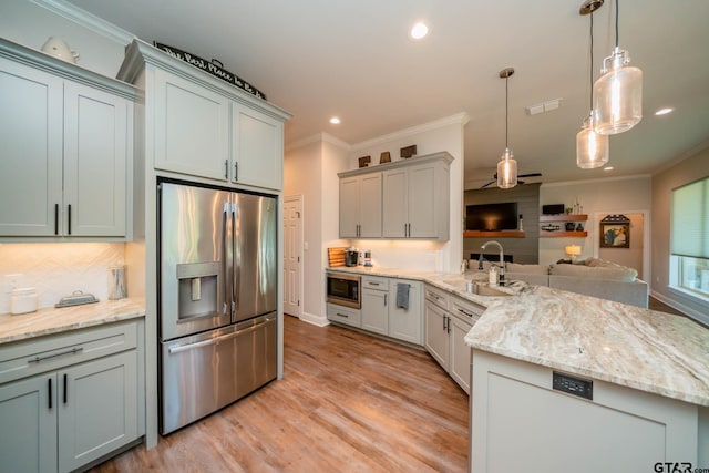 4523 Lone Oak Ln, Longview, TX 75605 - kitchen featuring appliances with stainless steel finishes, a peninsula, ornamental molding, decorative backsplash, and open floor plan