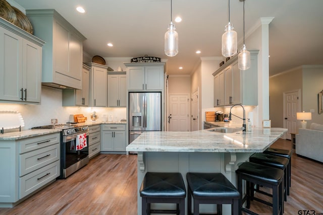 4523 Lone Oak Ln, Longview, TX 75605 - kitchen with stainless steel appliances, a peninsula, crown molding, light wood-style flooring, and light stone counters