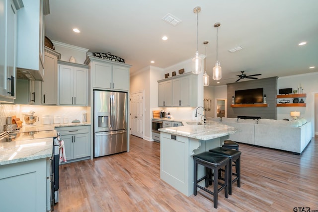 4523 Lone Oak Ln, Longview, TX 75605 - kitchen with stainless steel appliances, crown molding, a peninsula, a kitchen breakfast bar, and open floor plan