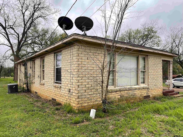 view of property exterior featuring cooling unit and a yard