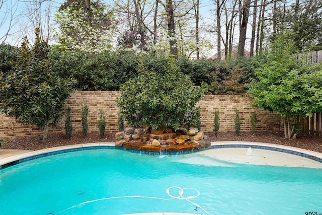 view of swimming pool with a fenced in pool and a fenced backyard