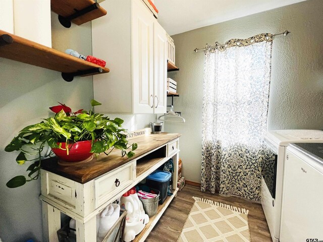902 S Florey, Mount Pleasant, TX 75455 - laundry room featuring separate washer and dryer, wood finished floors, and cabinet space