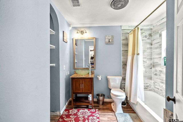 902 S Florey, Mount Pleasant, TX 75455 - full bath with wood finished floors, vanity, toilet, and shower / bath combination with curtain