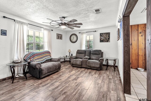 902 S Florey, Mount Pleasant, TX 75455 - living area with ceiling fan, light wood finished floors, ornamental molding, and a textured ceiling