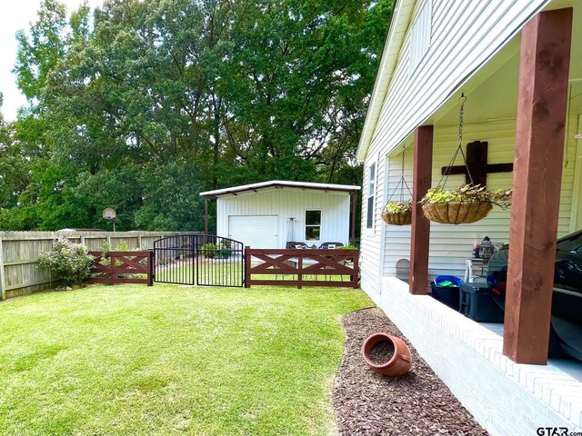 902 S Florey, Mount Pleasant, TX 75455 - view of yard featuring an outbuilding, a detached garage, and a gate