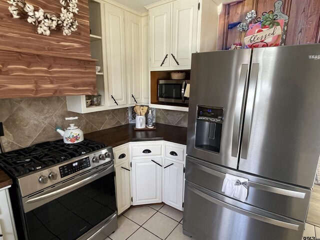 902 S Florey, Mount Pleasant, TX 75455 - kitchen with appliances with stainless steel finishes, dark countertops, backsplash, and open shelves
