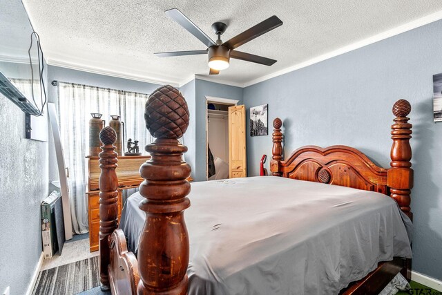 902 S Florey, Mount Pleasant, TX 75455 - bedroom with a textured ceiling, ornamental molding, a ceiling fan, baseboards, and a closet