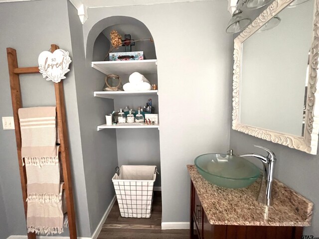 902 S Florey, Mount Pleasant, TX 75455 - bathroom featuring wood finished floors, vanity, and baseboards