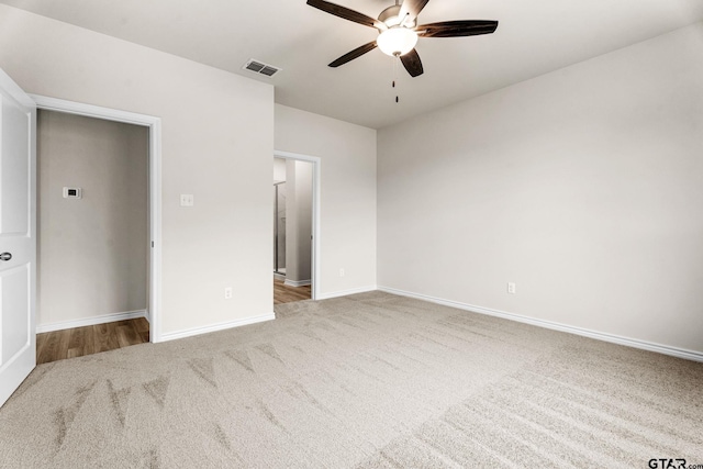 unfurnished bedroom with light colored carpet and ceiling fan