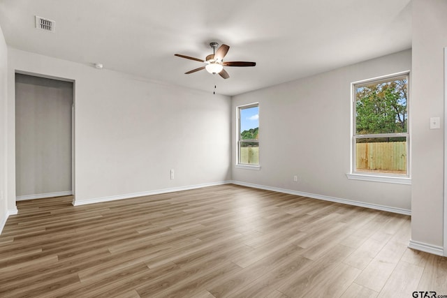 spare room featuring light wood-type flooring and ceiling fan