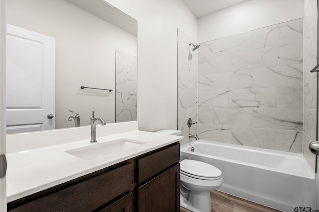 full bathroom featuring vanity, toilet, tiled shower / bath, and hardwood / wood-style flooring