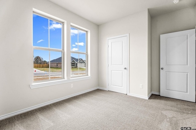 unfurnished bedroom with light colored carpet