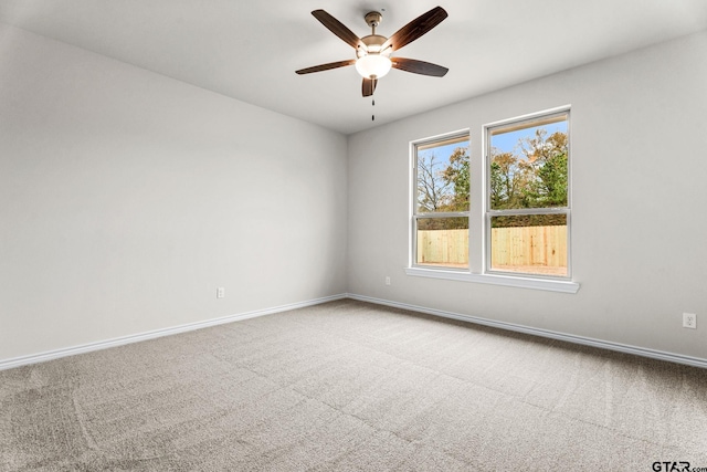 spare room featuring ceiling fan and carpet floors