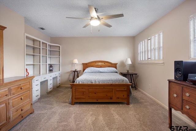 2733 Rockbridge Rd, Tyler, TX 75701 - bedroom featuring light colored carpet, a desk, a textured ceiling, and a ceiling fan