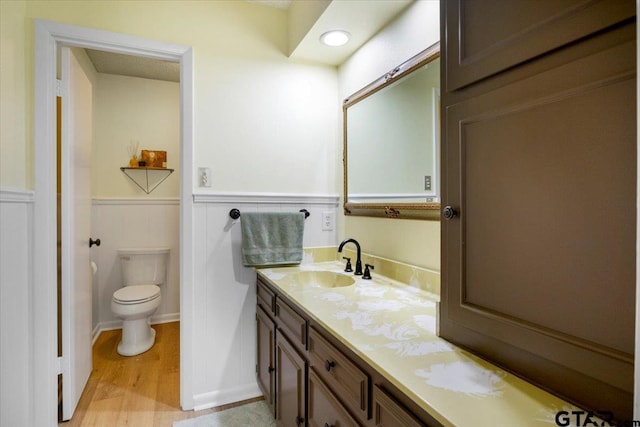 2733 Rockbridge Rd, Tyler, TX 75701 - bathroom featuring wood finished floors, vanity, and wainscoting