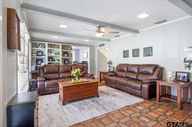 2733 Rockbridge Rd, Tyler, TX 75701 - living room featuring crown molding, a textured ceiling, stairs, beamed ceiling, and a ceiling fan