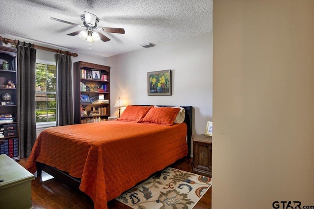 2733 Rockbridge Rd, Tyler, TX 75701 - bedroom featuring wood finished floors, a textured ceiling, and ceiling fan