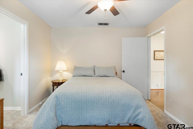 2733 Rockbridge Rd, Tyler, TX 75701 - bedroom featuring light carpet, a ceiling fan, and a textured ceiling